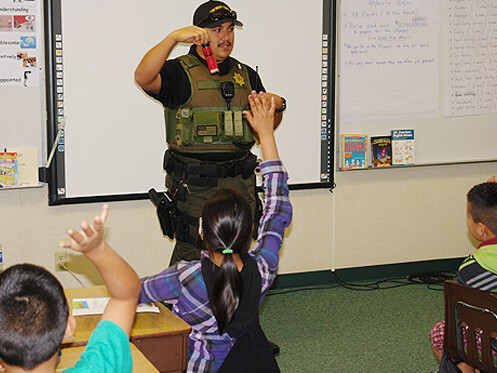 Deputy talking to kids in classroom